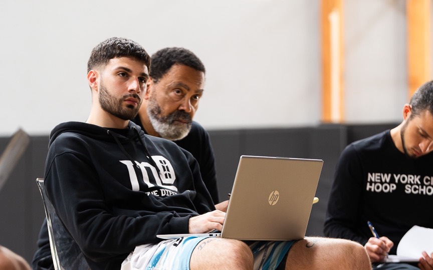 An academy owner stuck on a laptop at the side of his own session